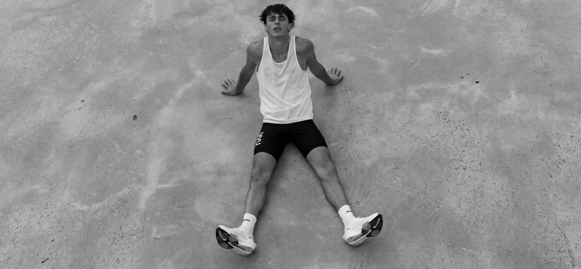 Athlete resting on concrete after training