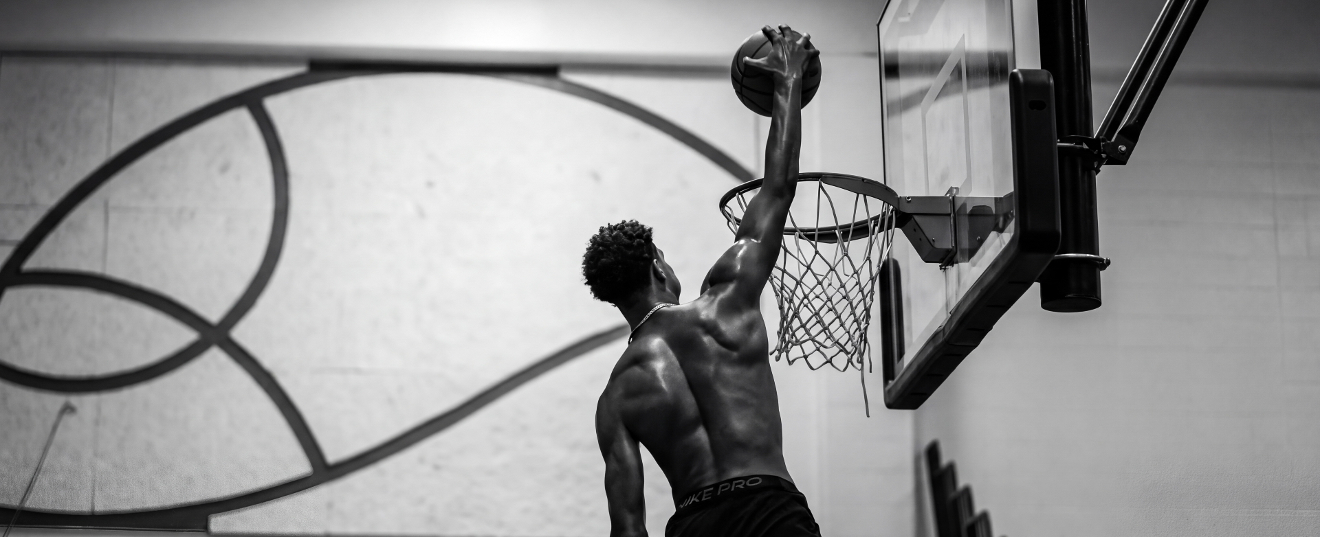 Athlete reaching toward a basketball rim